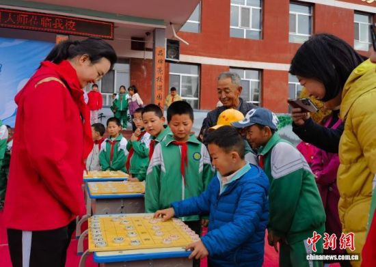 图为唐丹与湟源县城关第三小学的数十名学生进行象棋“车轮战”。张海雯摄 图为唐丹与湟源县城关第三小学的数十名学生进行象棋“车轮战”。张海雯摄